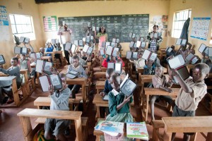 Kenya Classroom - holding up ereaders World Reader